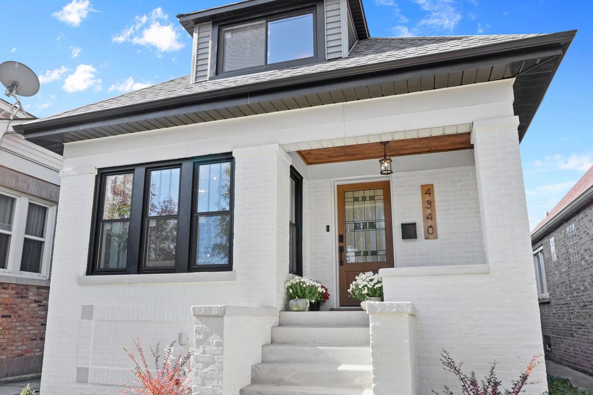 Restored Chicago brick bungalow, hipped roof and raised entry. The housing stock in Auburn Gresham is mostly brick bungalows.