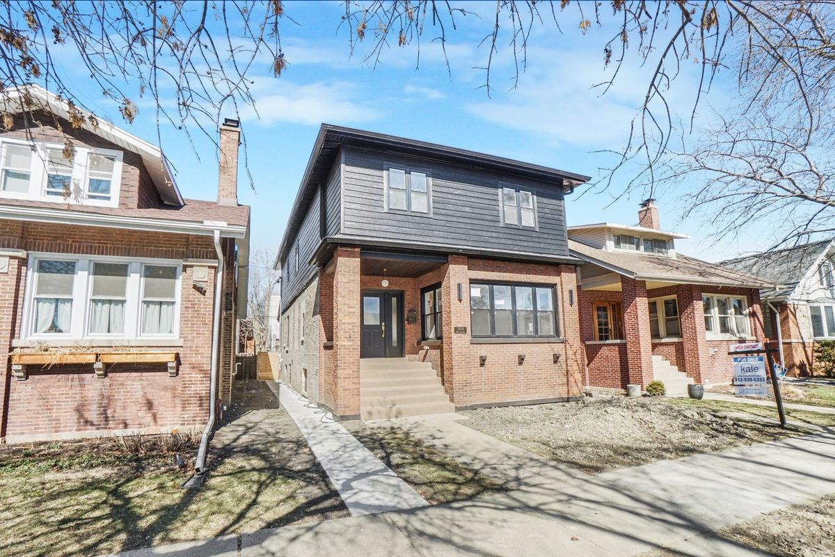 Brick front elevation and entry on a bungalow block. The housing stock in West Rogers Park is mostly brick bungalows.