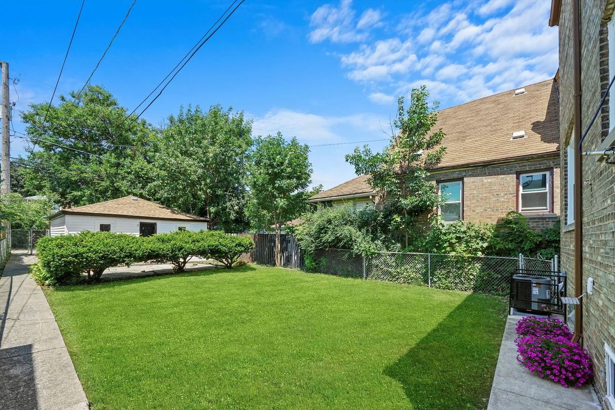 Rear elevation, masonry and fence line rebuilt. The housing stock in Lakeview and Wrigleyville is mostly brick two-flats.